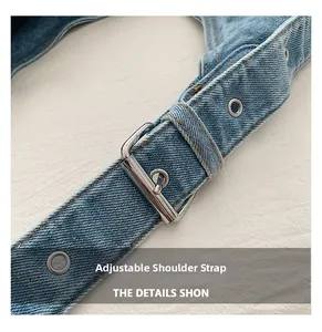 Detail of adjustable denim shoulder strap with silver metal buckles and eyelets