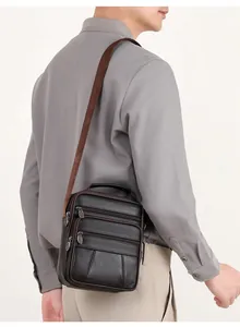 Deep brown genuine leather messenger bag with multiple zipper pockets and top handle