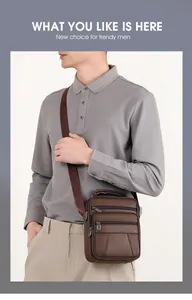 Detail of brown leather messenger bag featuring multiple zipper pockets and lychee texture