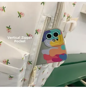 Detailed view of the functional vertical zipper pocket on floral print backpack side