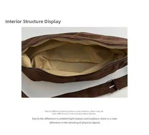 Detailed interior of a large brown suede bag showing light fabric lining and spacious main compartment