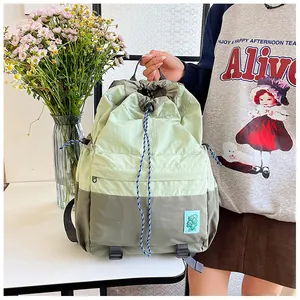 Detailed close-up of a two-tone drawstring backpack with nylon fabric and durable stitching