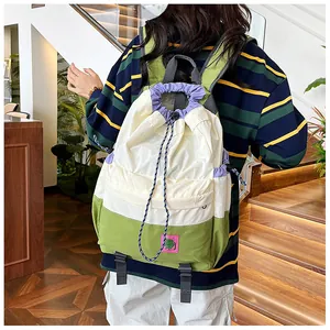Detail of color-block drawstring backpack with adjustable gray shoulder straps