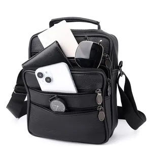 Black pebbled leather men's messenger bag with multiple zipper pockets and top handle