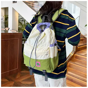 Detailed shot of a lightweight drawstring backpack with purple and green accents