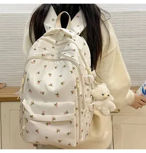 Close-up of lightweight floral backpack with bear charm and adjustable buckles