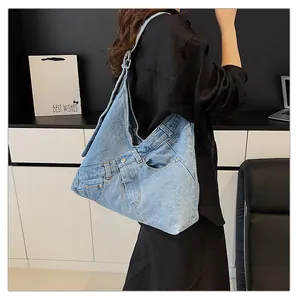 Detail of upcycled denim shoulder bag with metal buttons and jeans pocket design