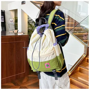 Detailed view of tricolor drawstring backpack showing embroidery patch and side texture