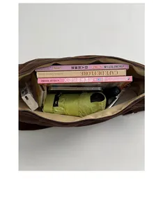 Internal view of brown large capacity tote bag showing books and umbrella storage