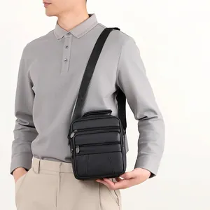 Minimalist black lychee pattern leather messenger bag for men shown on a model