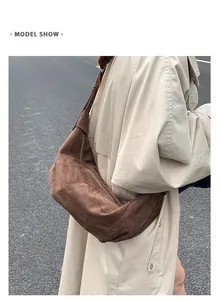 Brown suede dumpling bag worn with a beige trench coat for a stylish commuting look