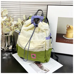 Detail of color-block drawstring backpack with durable nylon fabric and side pockets