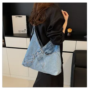 Detailed view of light blue denim tote with unique jeans waist and pocket design