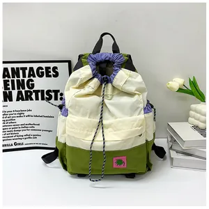 Detail of color-block drawstring backpack with adjustable cords and side pockets