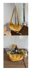 Detail view of mustard yellow suede crescent bag with textured finish and zipper closure