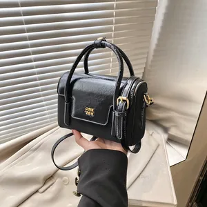 Fashionable black glossy square handbag with gold COIH 2DN hardware and top handle
