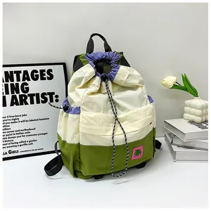 Detail of drawstring backpack showing tri-color nylon stitching and floral patch