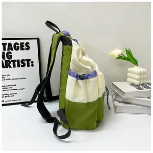 Detail view of large drawstring backpack side pocket with adjustable black shoulder straps
