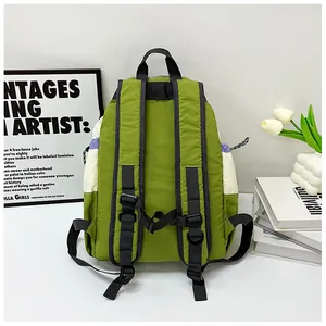 Macro shot of green nylon backpack back straps with adjustable buckles in a modern room
