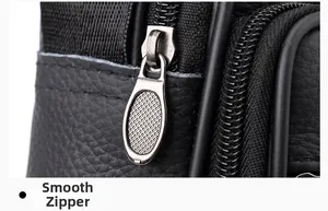 Nahaufnahme von glattem Reißverschluss und mattem Metallschieber auf schwarzer Ledertasche