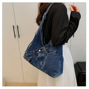 Detailed close-up of dark blue denim canvas bag featuring creative jeans pocket design
