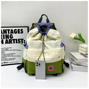 Detail of color-block drawstring backpack with adjustable cords and side storage pocket