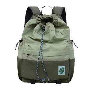 Lightweight drawstring backpack for students with color-block green nylon and zipper pocket