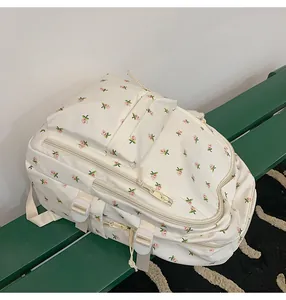 Detail view of the floral print backpack side pockets and adjustable straps