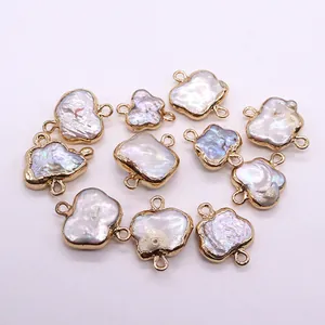 Macro view of natural baroque pearl butterfly connector with light gold plating for DIY jewelry