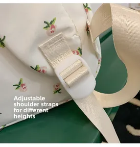 Close-up of adjustable strap buckle on floral backpack for height customization