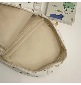 Interior view of floral backpack showing spacious main compartment and zip pocket