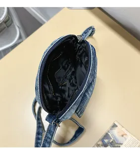 Top view of denim crossbody bag showing interior lining and zipper closure details
