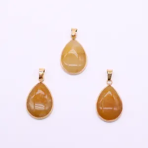 Three teardrop-shaped yellow stone pendants with gold plated metal edges and bails