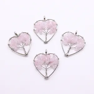 Detail of heart-shaped life tree pendants with pink natural stones and silver wire wrapping