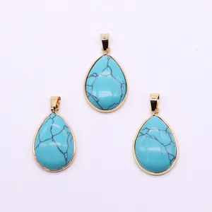 Detailed view of three pear-shaped teardrop pendants with gold plated bezel setting