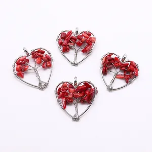 Detail of four silver tree of life heart pendants with vibrant red gravel stones