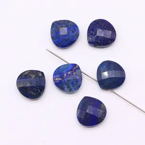 Macro detail of faceted heart-shaped lapis lazuli beads with natural pyrite spots and drill holes