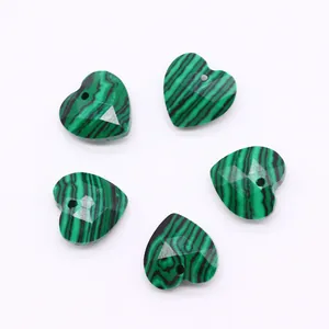 Macro view of 5 faceted heart-shaped malachite stone beads for DIY jewelry making