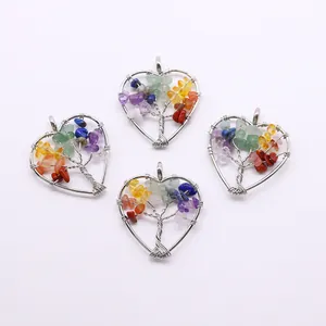 Close-up of heart-shaped tree of life pendants with colorful natural stone chips