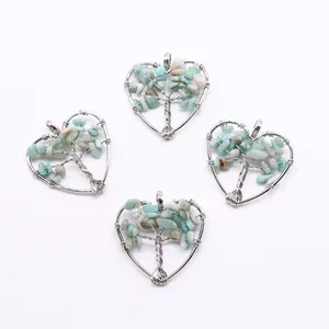 Detail of four heart-shaped tree of life pendants with silver wire wrap and blue stones