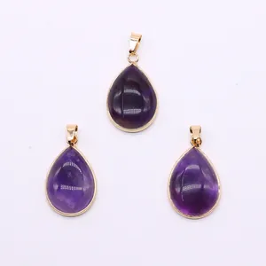Detailed view of three purple crystal teardrop pendants with polished gold-plated edges