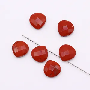 Detailed macro view of faceted red jasper heart stone bead with natural black veins