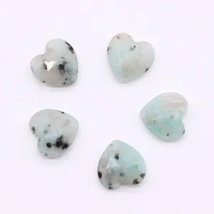 Macro shot of five faceted heart-shaped natural stone pendants for DIY necklace jewelry
