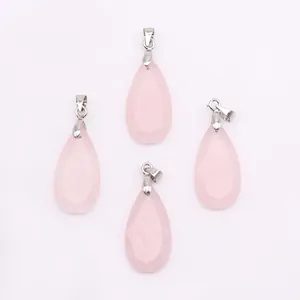 Detailed view of faceted pear-shaped rose quartz crystal pendants with silver metal clasps