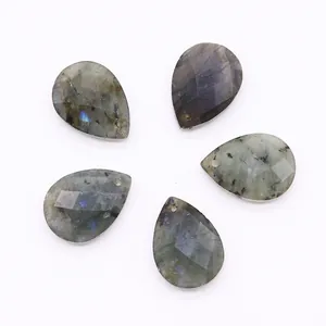 Macro view of five faceted labradorite teardrop pendants with natural blue flash and top holes