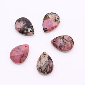 Macro shot of five faceted teardrop pink stone pendants with natural veined textures
