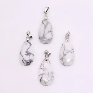 Detailed view of four teardrop-shaped white howlite stone pendants with marble texture