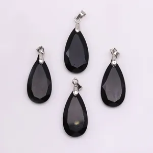 Macro view of four faceted black natural stone teardrop pendants with silver metal clasps
