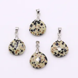 Detailed view of faceted teardrop dalmatian jasper pendants with silver metal clasps