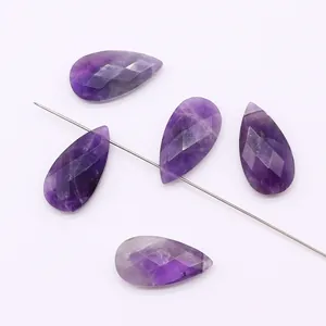 Detailed view of faceted purple teardrop stone beads for DIY jewelry making